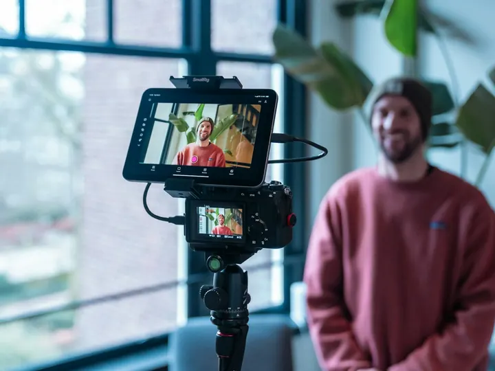 Content creator filming himself with a camera