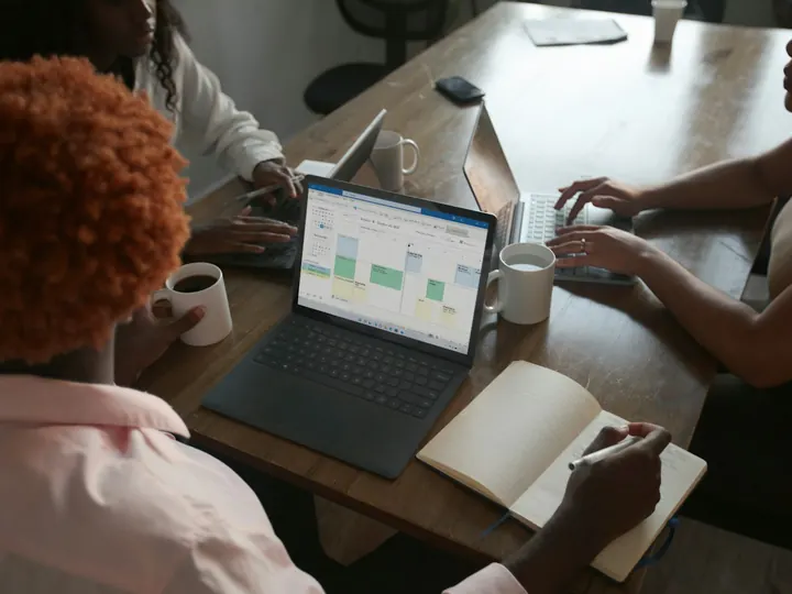 Business meeting around a laptop
