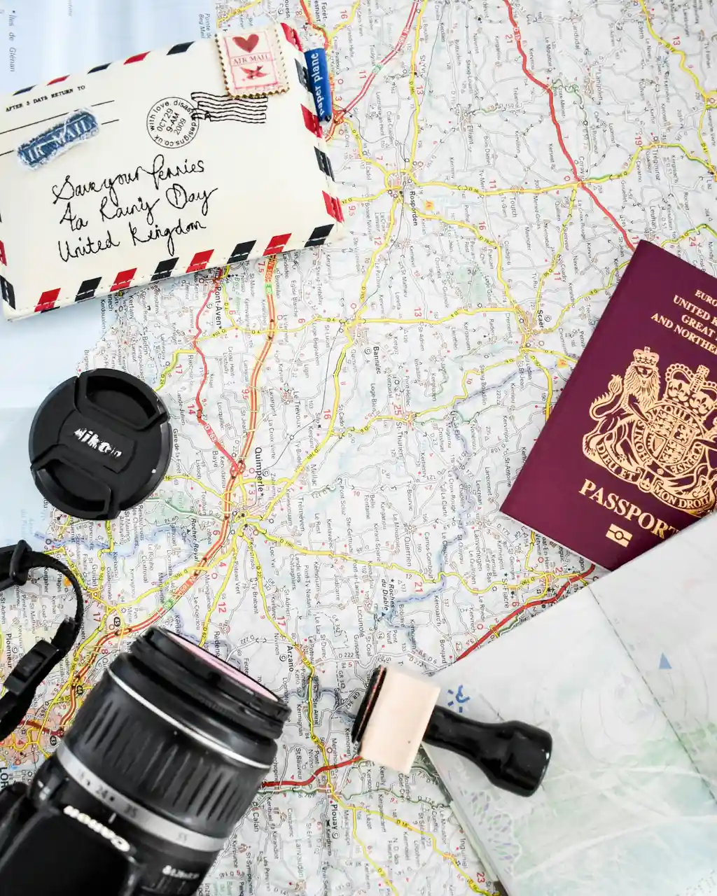 Passport, map and travel documents laid out on a table