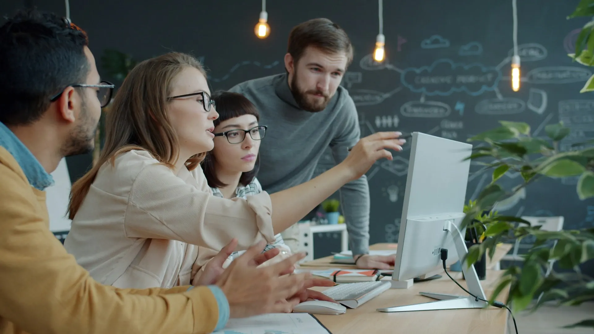 Consultants discussing a case at a computer