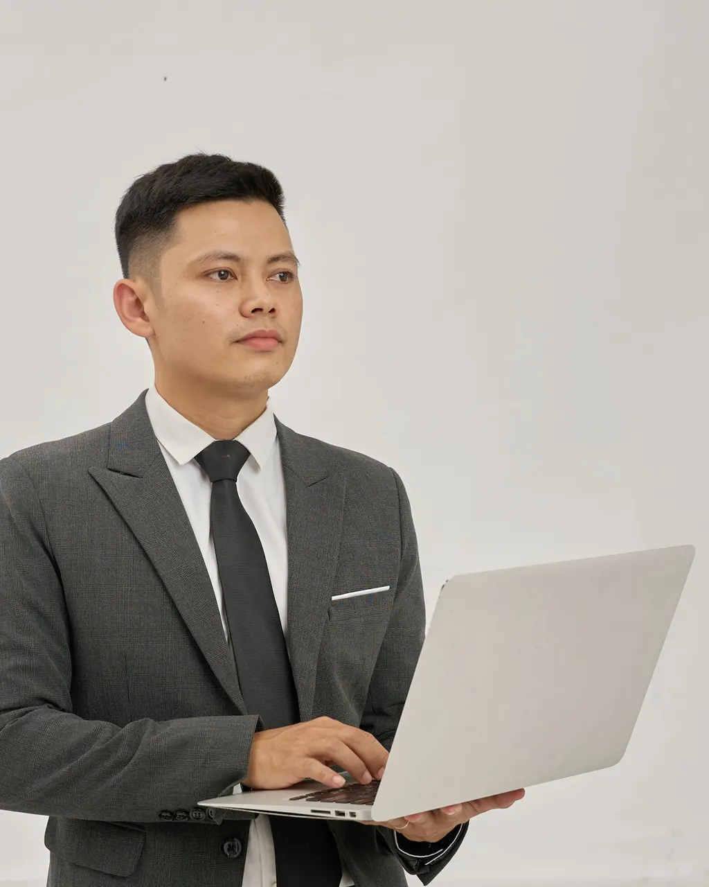 Businessman in a suit holding a laptop