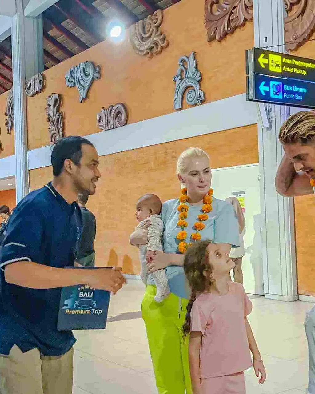 Family with young children welcomed by a Bali Premium Trip agent at Ngurah Rai arrivals